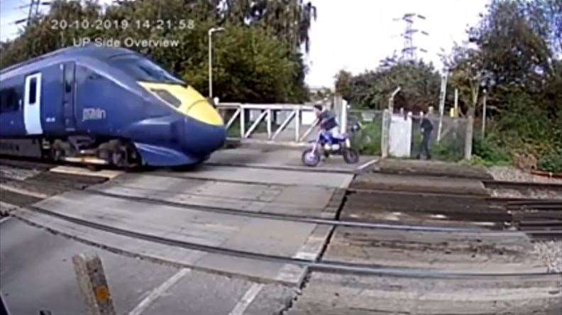 Footage released by Network Rail shows a near miss between a motorcyclist and a train (20074394)