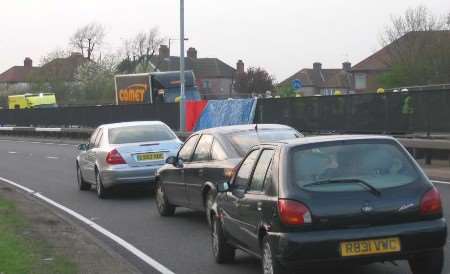 The emergency services working behind the fence the driver hit. Picture: HELEN COCKERSOLE