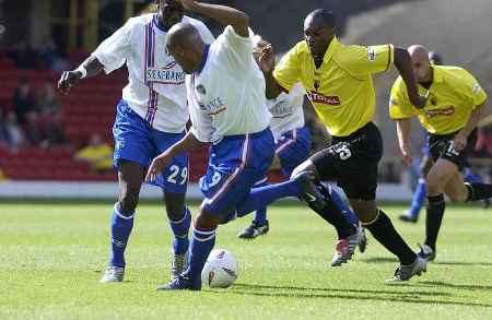 Marlon King (No 9) in a tussle for the ball with Marcus Gayle at Watford. Picture: PAUL DENNIS