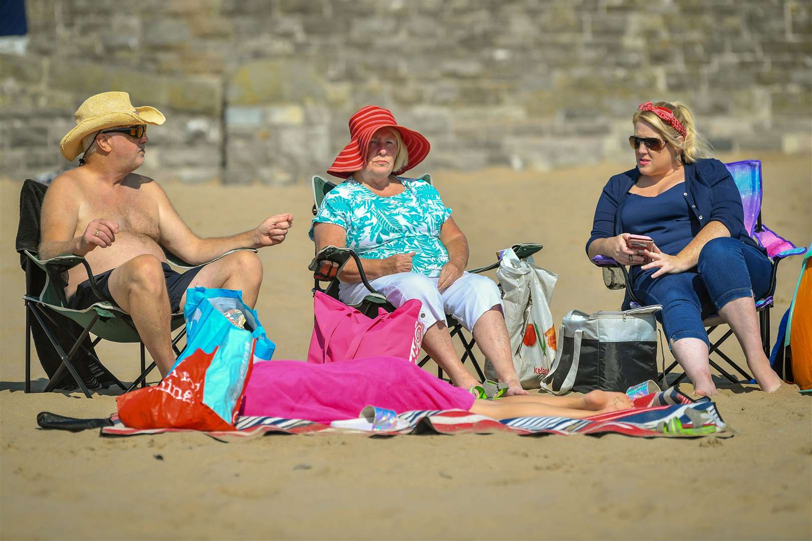 People enjoy the sun at Barry Island (Ben Birchall/PA)