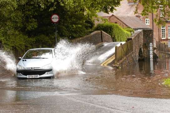 A car drives through the flooded Eynsford ford (file picture)