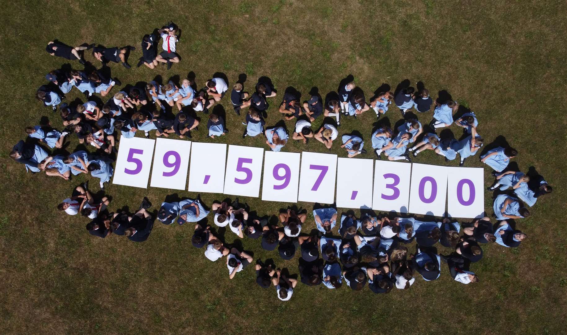 Pupils from St Alban’s Primary School in Havant hold up numerical placards to unveil the Census 2021 population of England and Wales (Matt Alexander/PA)