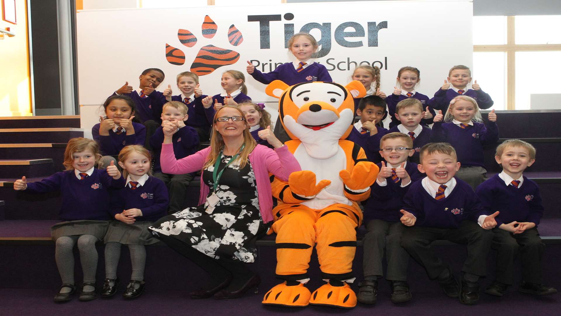 Mrs Charlotte Scott, principal, with mascot Tiggy and pupils of Tiger Primary School