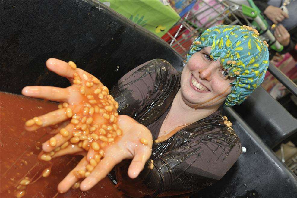 Ellie Whittaker sat in a bath of beans