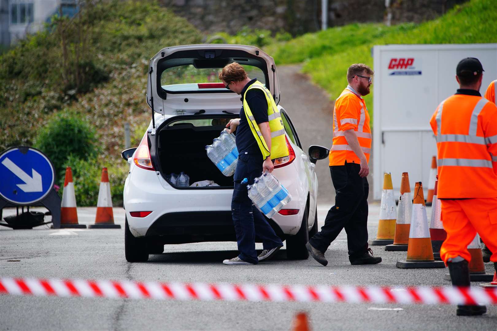 People collecting bottled water in Brixham, Devon (Ben Birchall/PA)