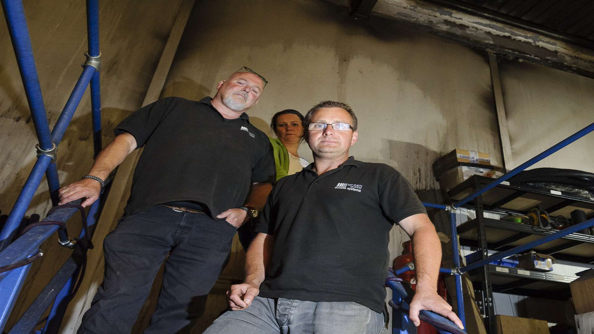 Mig Howard, Vicky Hills and manager Neil Sampson, with the smoke blackened back wall behind