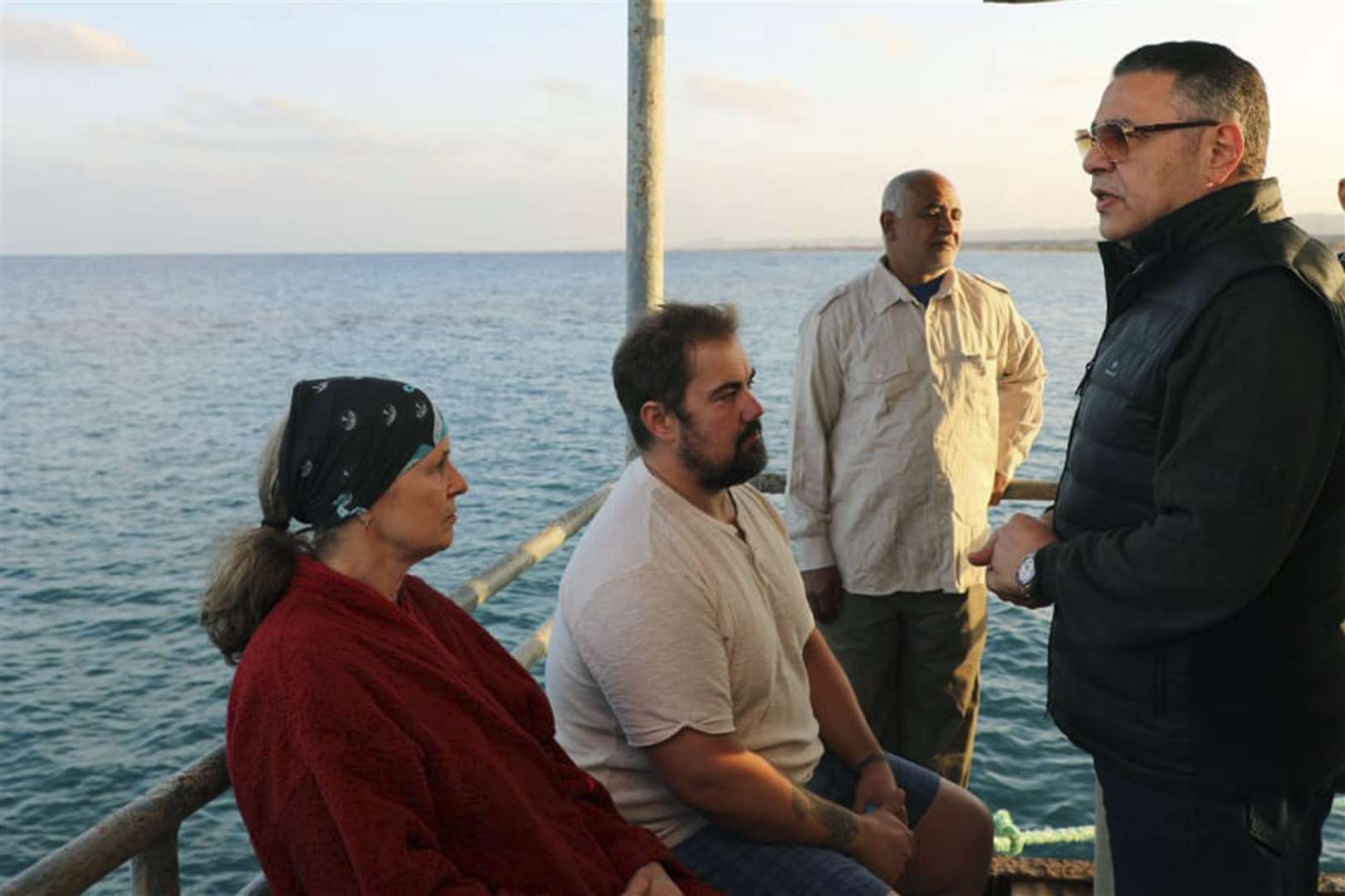 Amr Hanafi speaks to survivors (Egyptian Press Centre/AP)