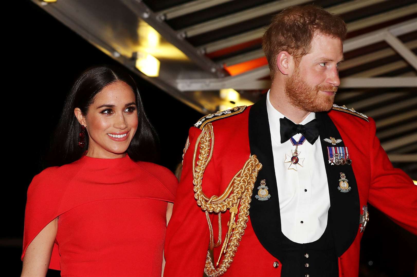 Harry, in a Royal Marines mess dress uniform, and Meghan at the Mountbatten Festival of Music in March 2020 (Simon Dawson/PA)