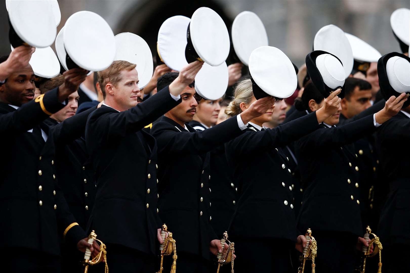 Britannia Royal Naval College officers raise their hats to the Prince of Wales (Peter Nicolls/PA)