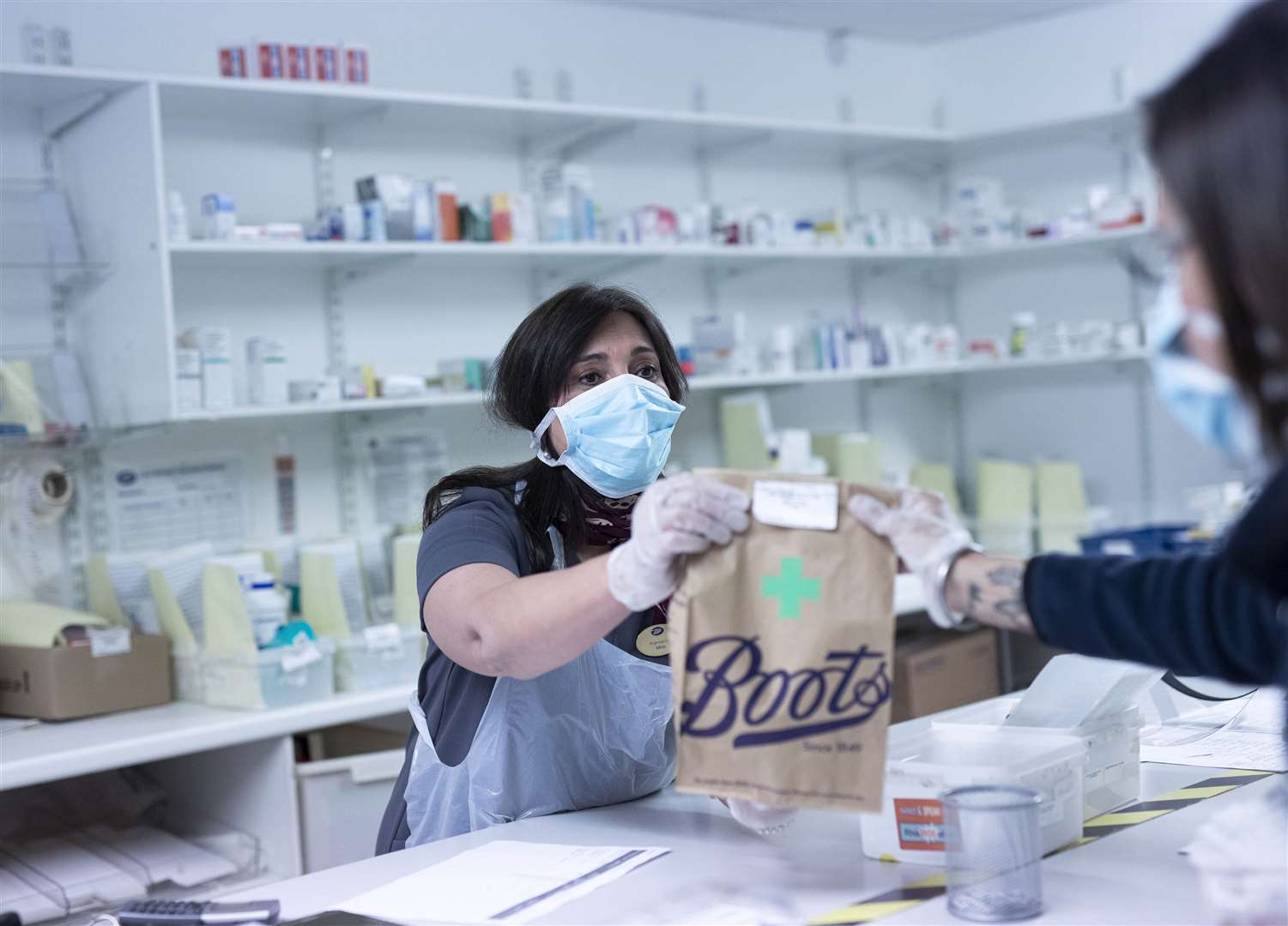 Pharmacist Mina Hunjan prepares medications at a Boots store for delivery to care homes (Fabio De Paola/PA)