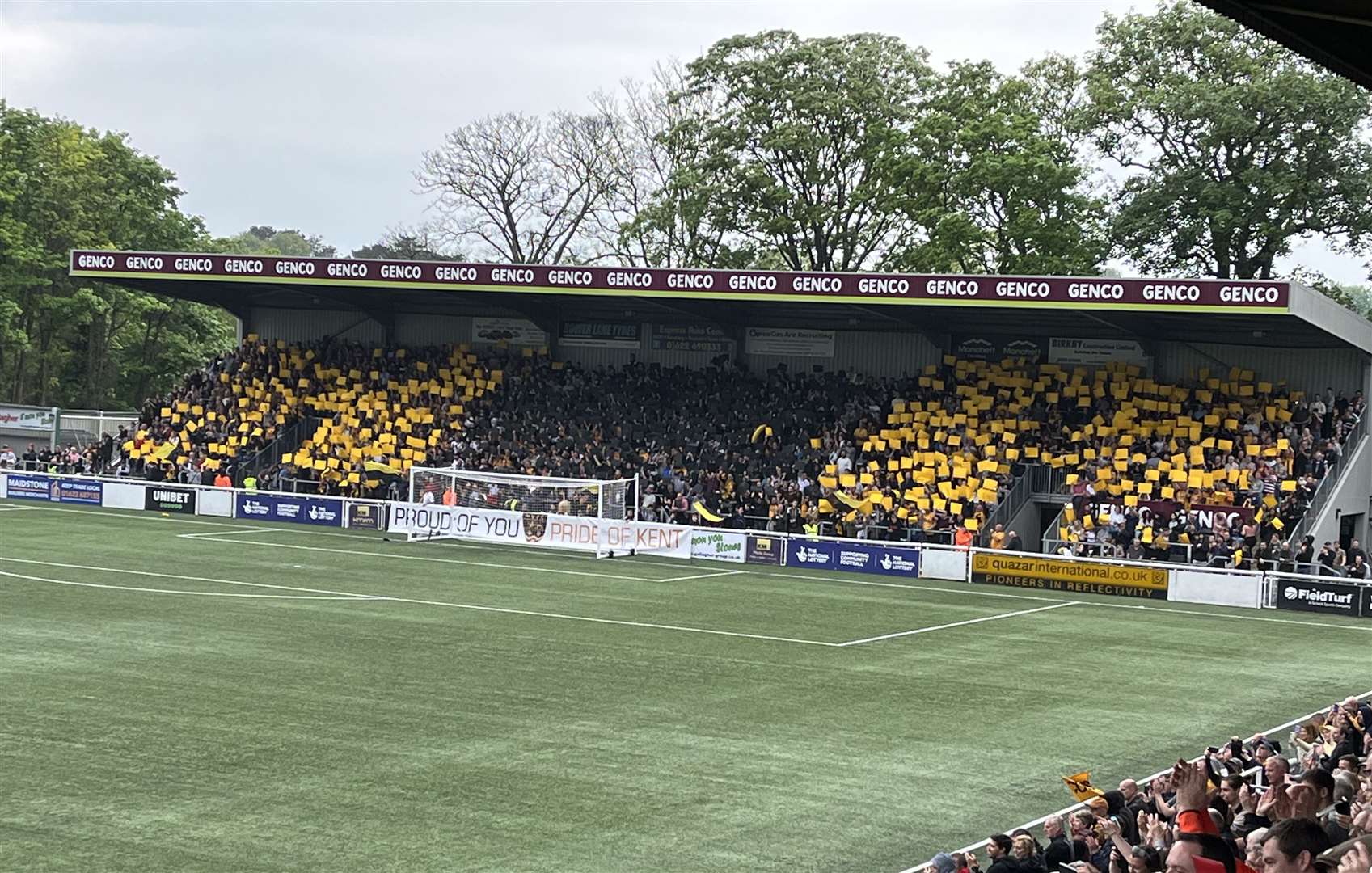 Maidstone fans welcome the champions on to the pitch before kick-off