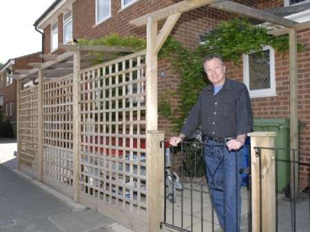 Derek Hatton with his trellis which needs planning permission