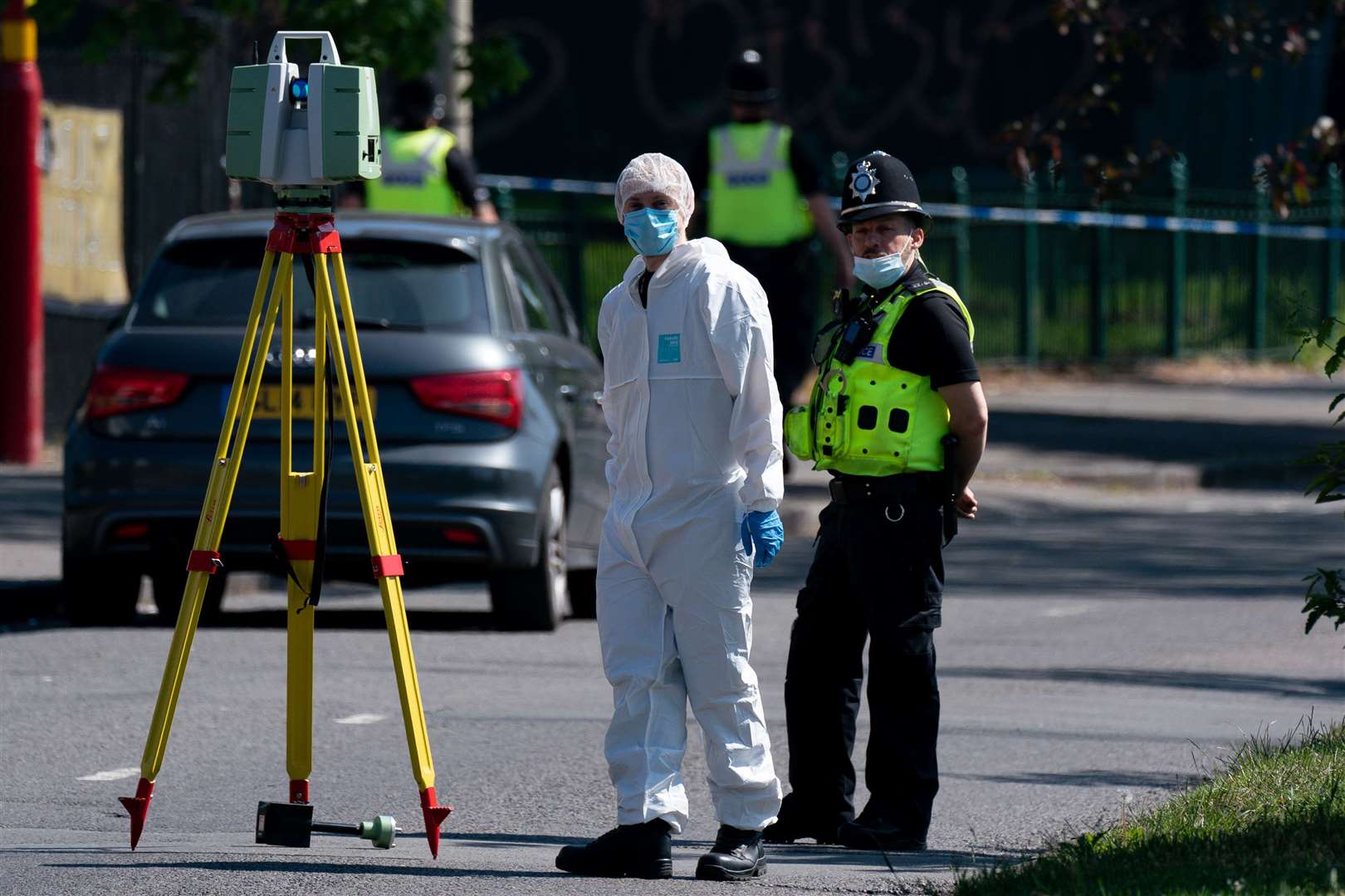 Police and forensics officers at the scene on College Road (Jacob King/PA)