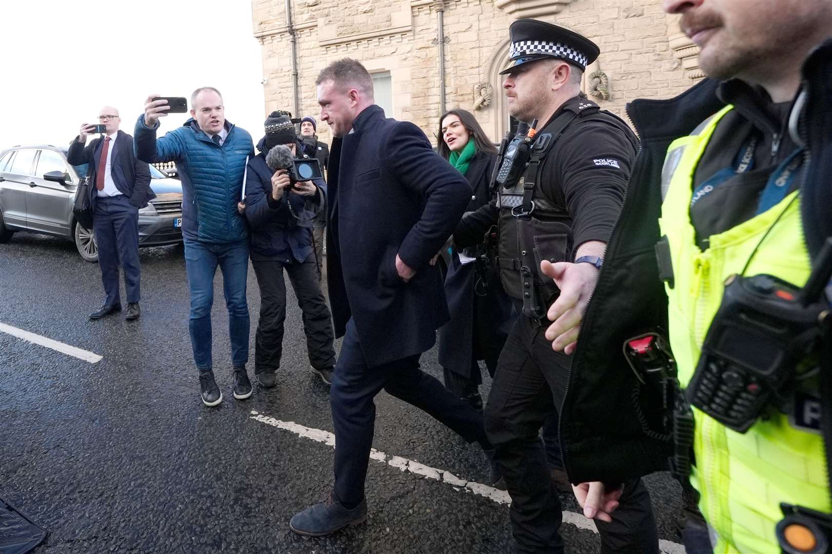 Stuart Hogg, centre, was escorted to a waiting car by police outside the court (Andrew Milligan/PA)