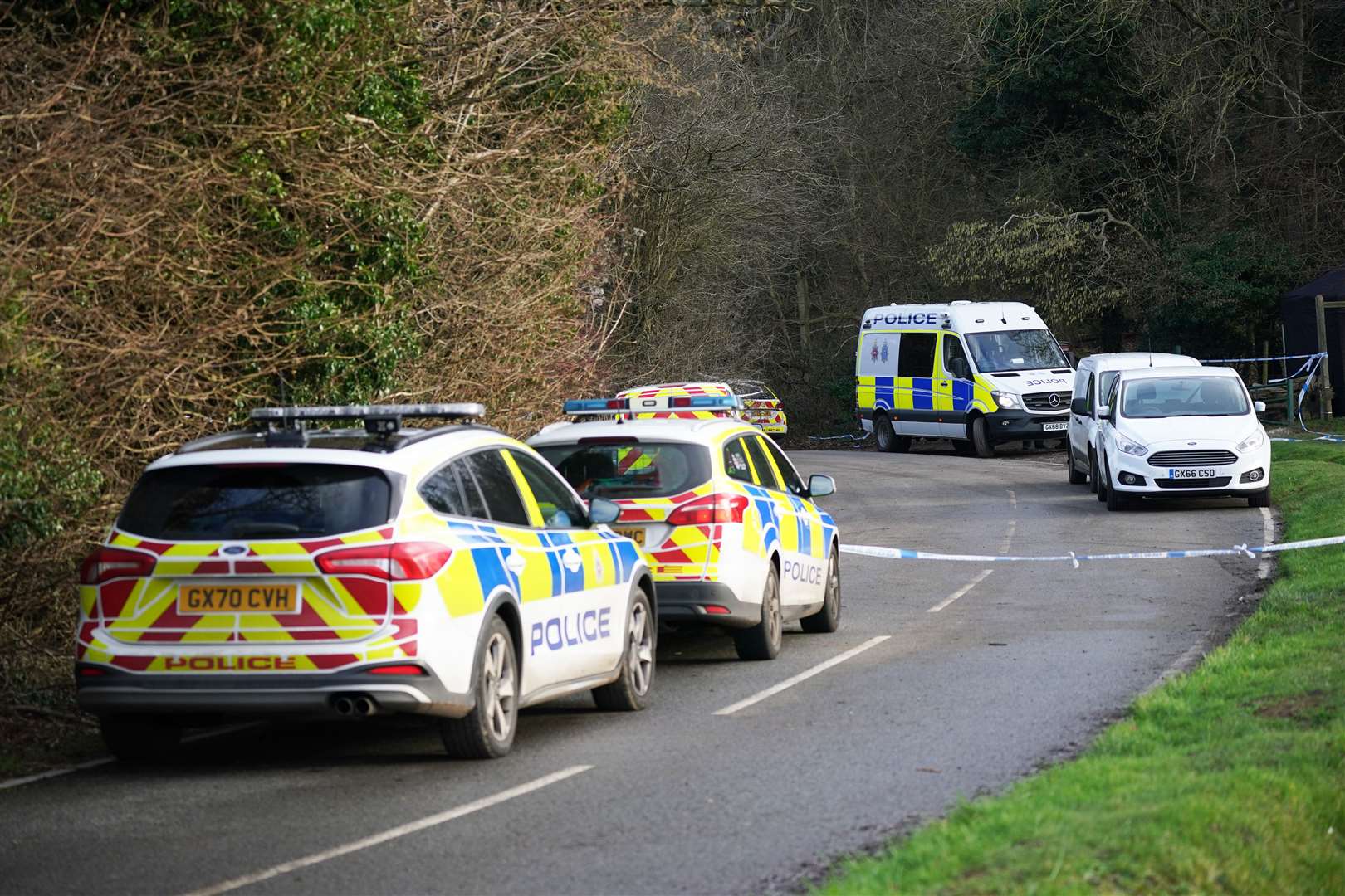 Police at the scene at Gravelly Hill in Caterham, Surrey (PA)