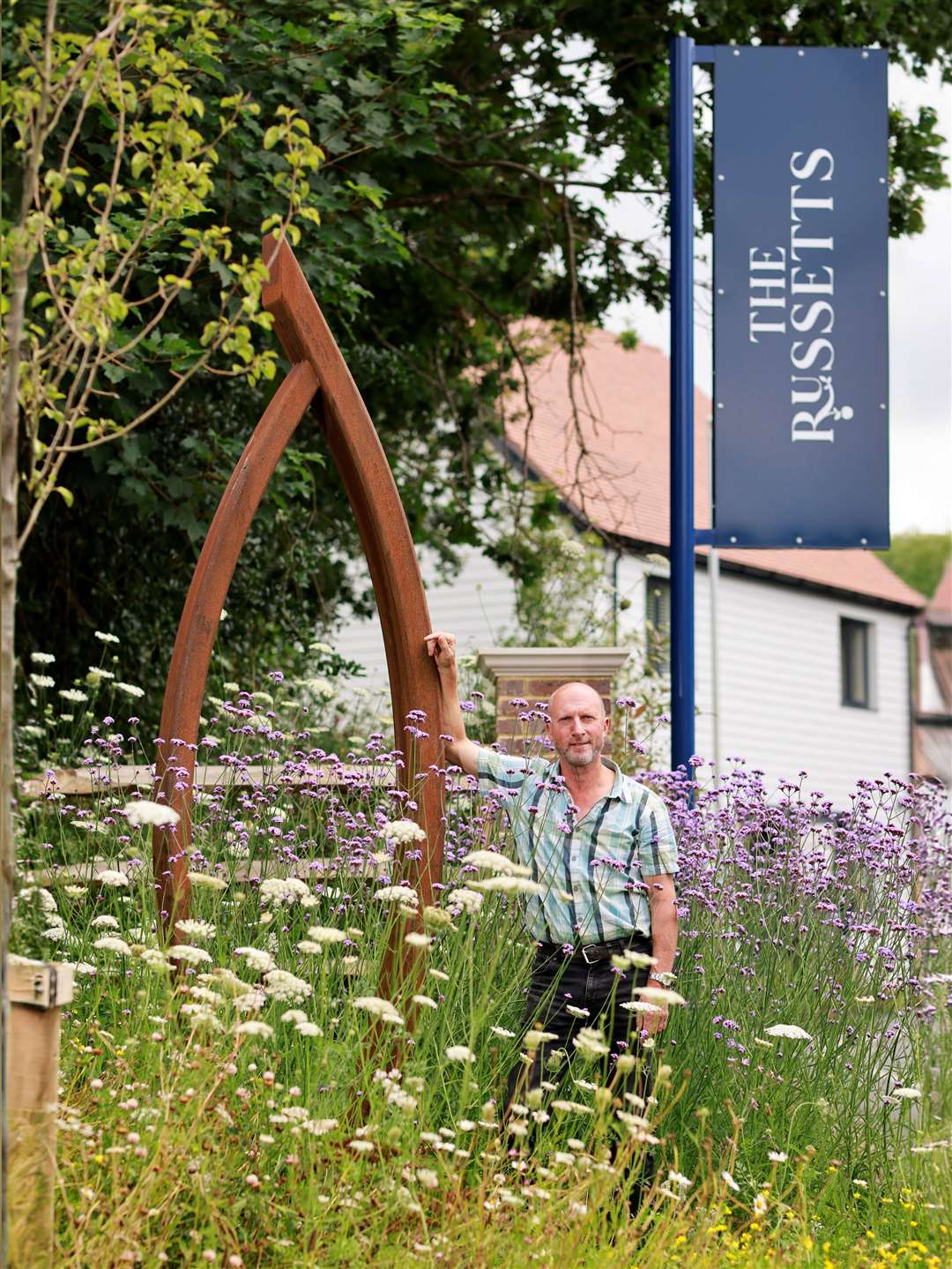 Simon Probyn with his sculpture named The Sail which he made in a day