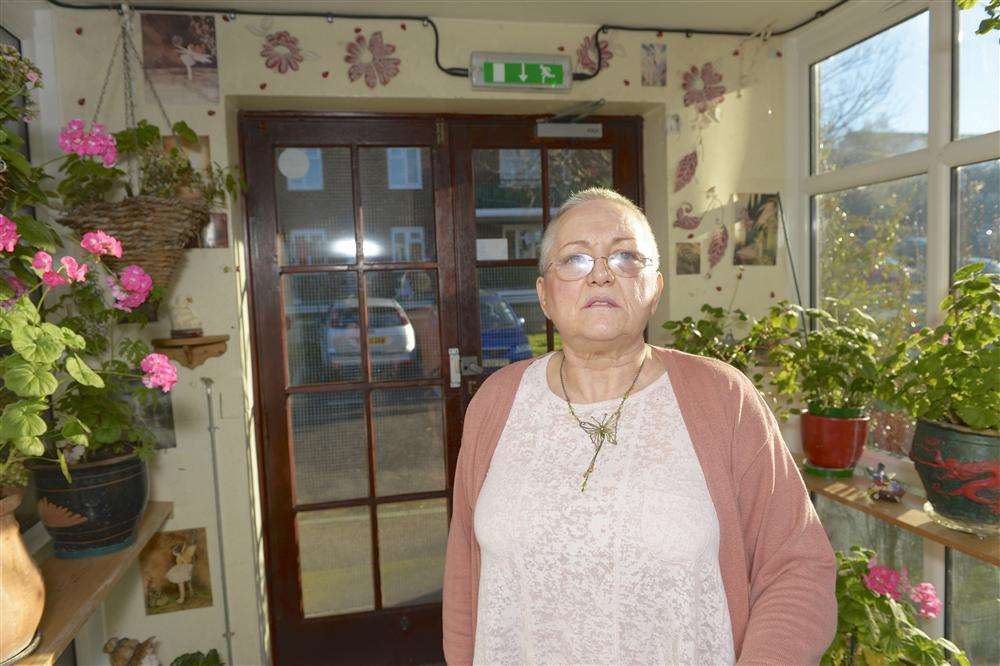 Brenda Brooks-Morgan with some of the pot plants she has been told she must move