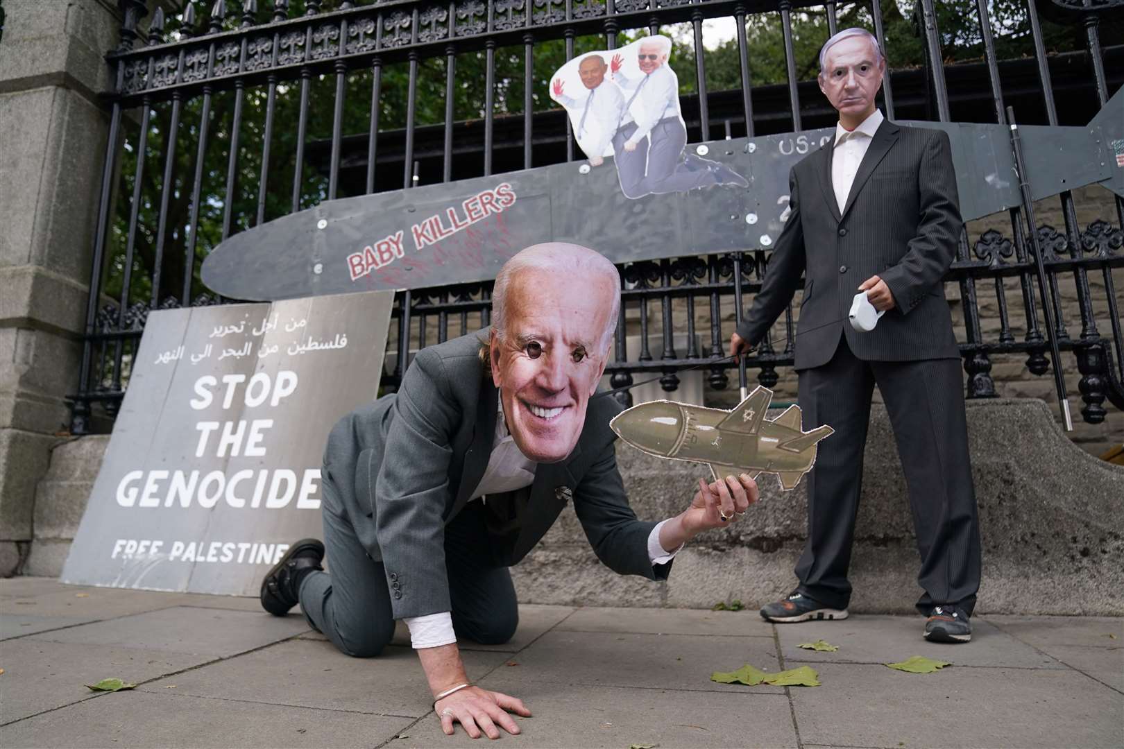 Protesters wearing a Joe Biden mask and Benjamin Netanyahu mask take part in a pro-Palestine protest outside the Merrion Square entrance to Leinster House, Dublin (Brian Lawless/PA)