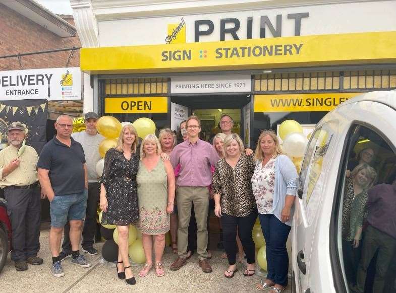 Staff from Singlewell Stationary and Print, including Simon pictured centre in the red, celebrate the firm's 50th birthday