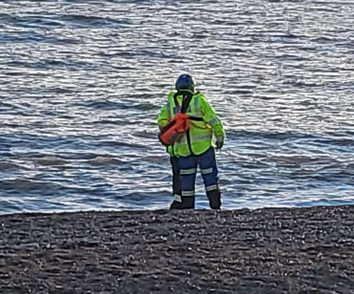 Coastguard crews can be seen searching the water in Hythe yesterday afternoon