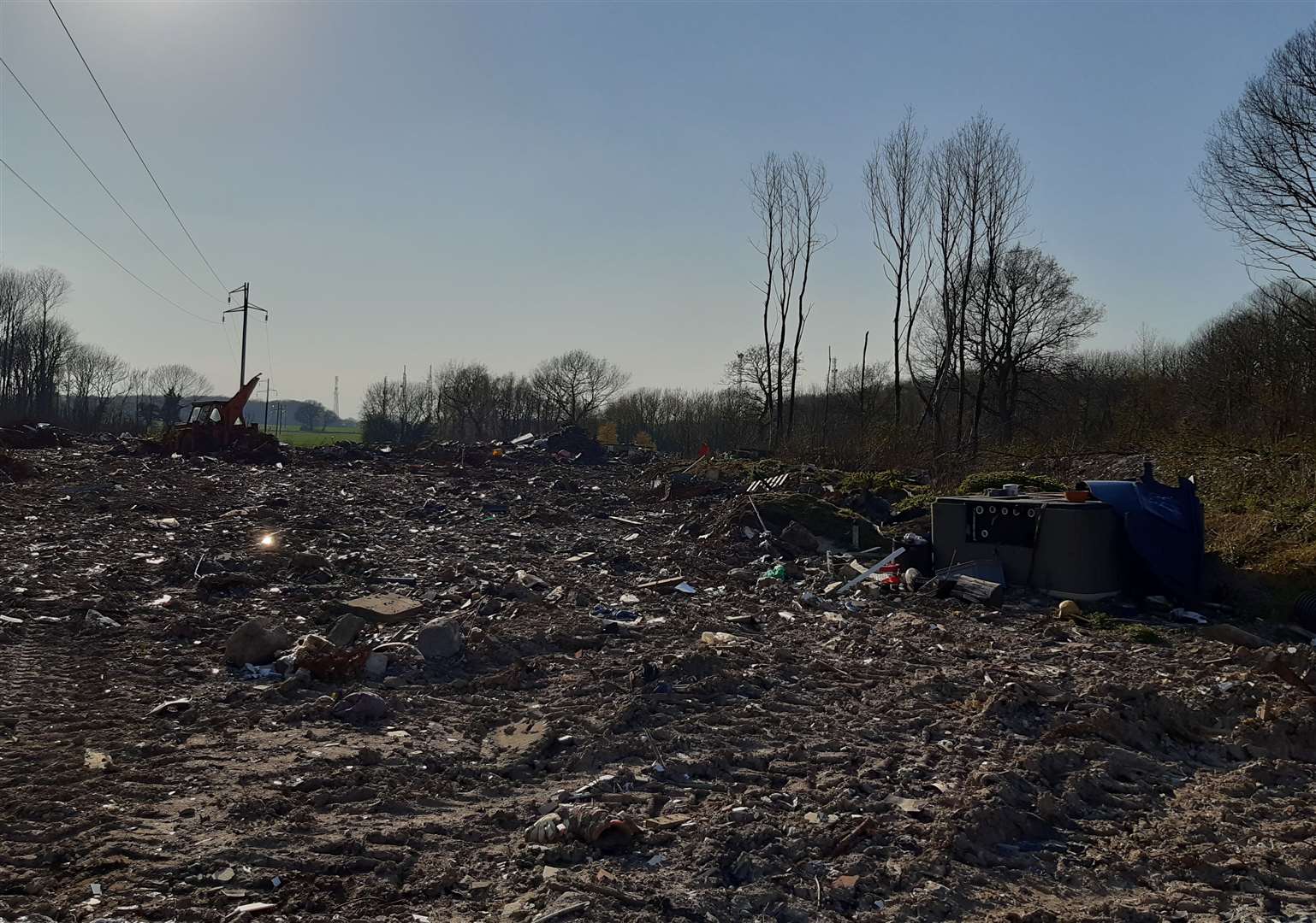 Rubble and rubbish can be seen in the site. Mr Beck maintains the trees in this section were taken down by UK Power Networks