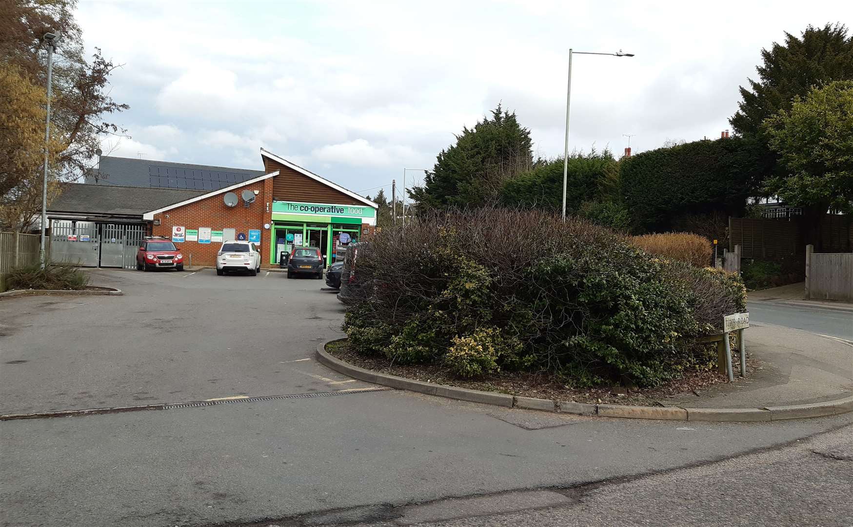 Bosses plan to cut part of the hedge down and extend the pavement at the junction with Tudor Road