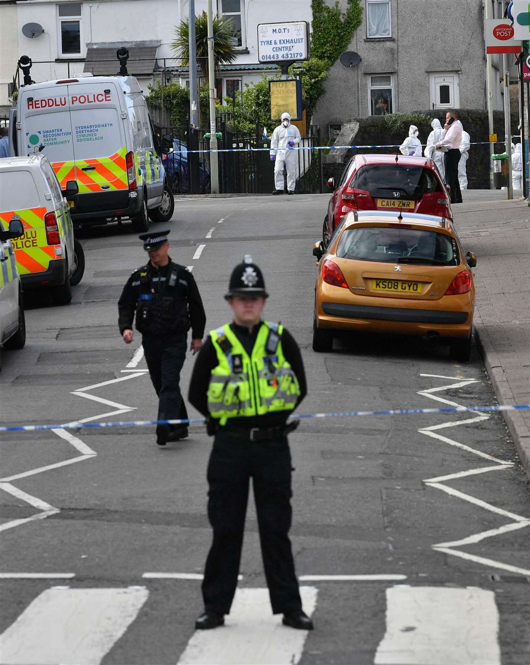 Police at the scene in Pen Y Graig (Ben Birchall/PA)