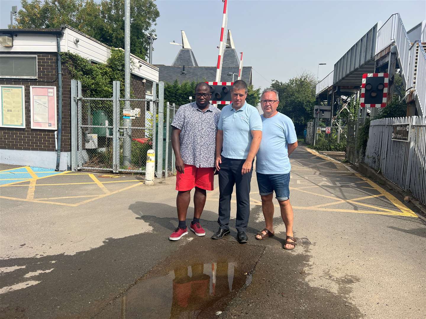 From left to right, Francis Atieku, Cllr Lloyd Bowen and Paul Goodman, next to the leak by Teynham Station