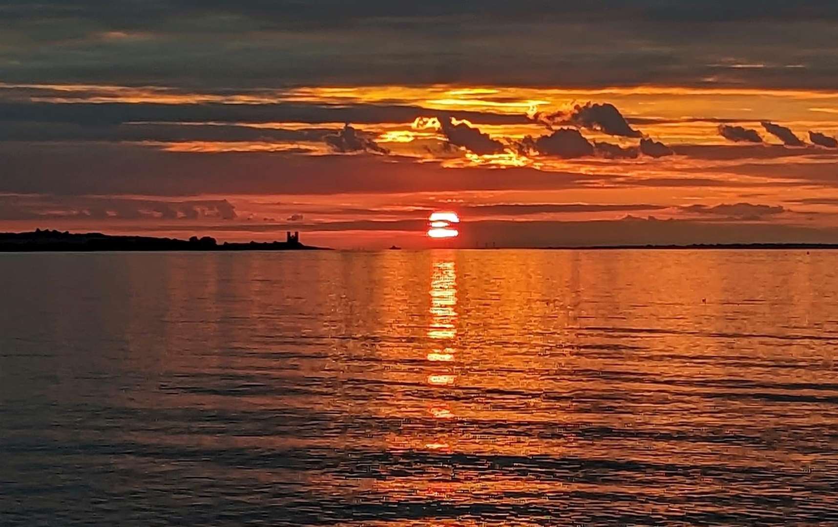 A stunning red sun peeking through the clouds. Pic: Jane White.