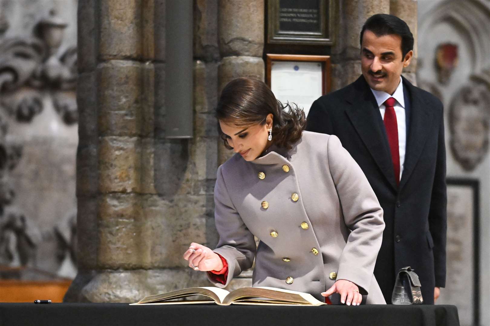 The Emir of Qatar Sheikh Tamim bin Hamad Al Thani and his wife Sheikha Jawaher, sign the guest book (Justin Tallis/PA)