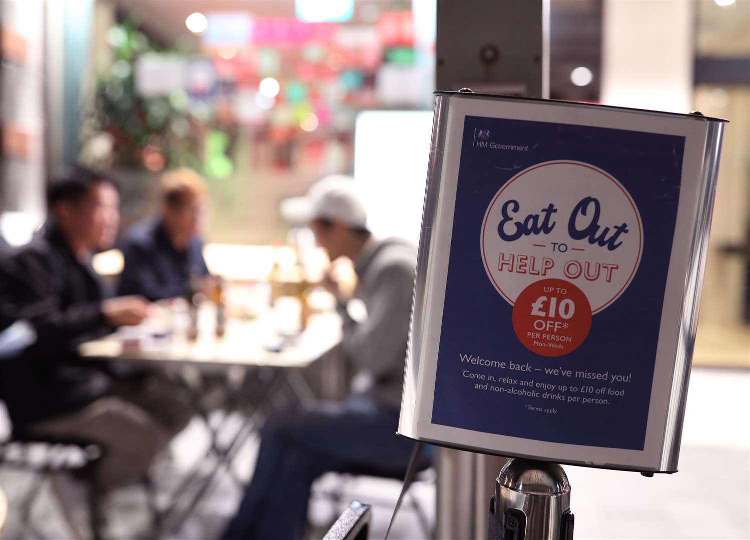 People eating on tables outside a restaurant in Chinatown in Soho, London earlier this year (Yui Mok/PA)