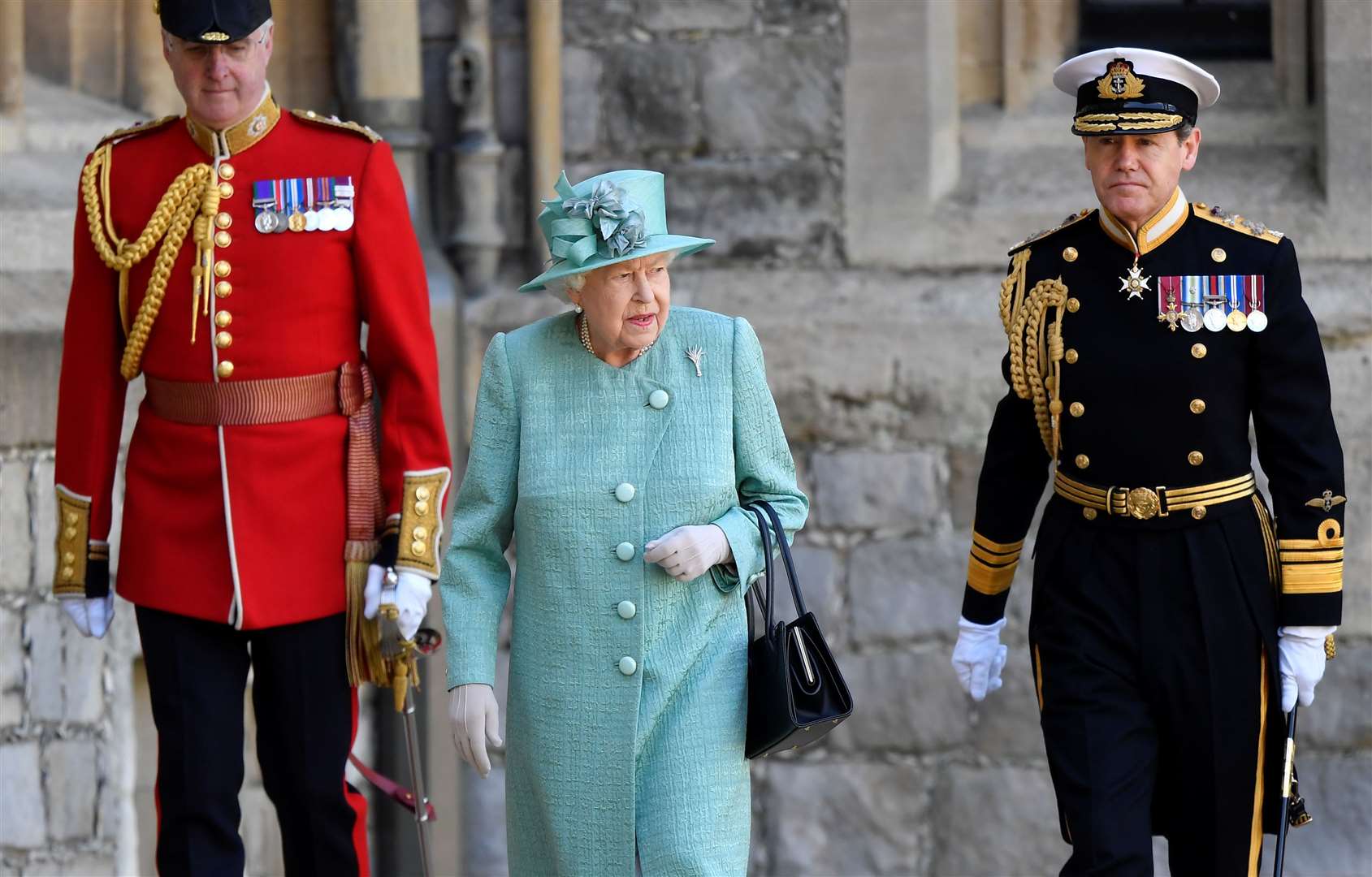 The Queen attended the ‘mini-Trooping’ ceremony flanked by Lieutenant Colonel Michael Vernon (left) and Vice Admiral Sir Tony Johnstone-Burt (Toby Melville/PA)