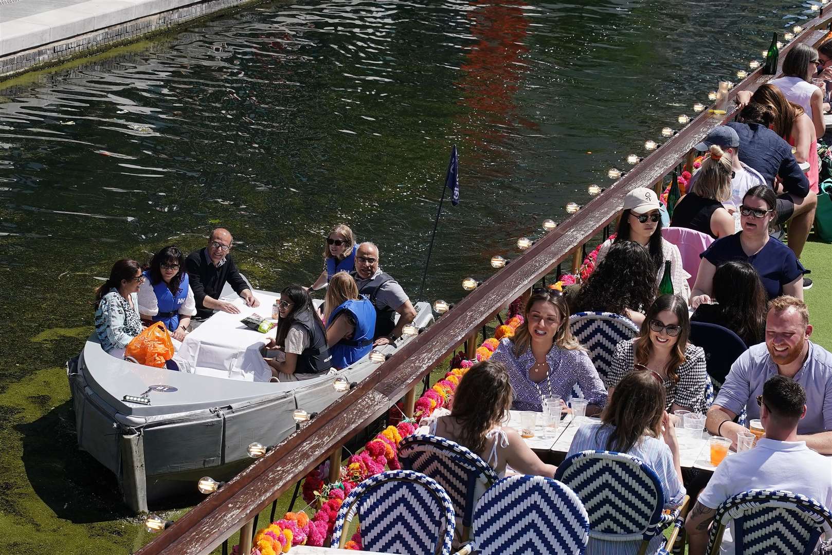 People enjoy the hot weather at the canal in Paddington Basin, north London (Aaron Chown/PA)