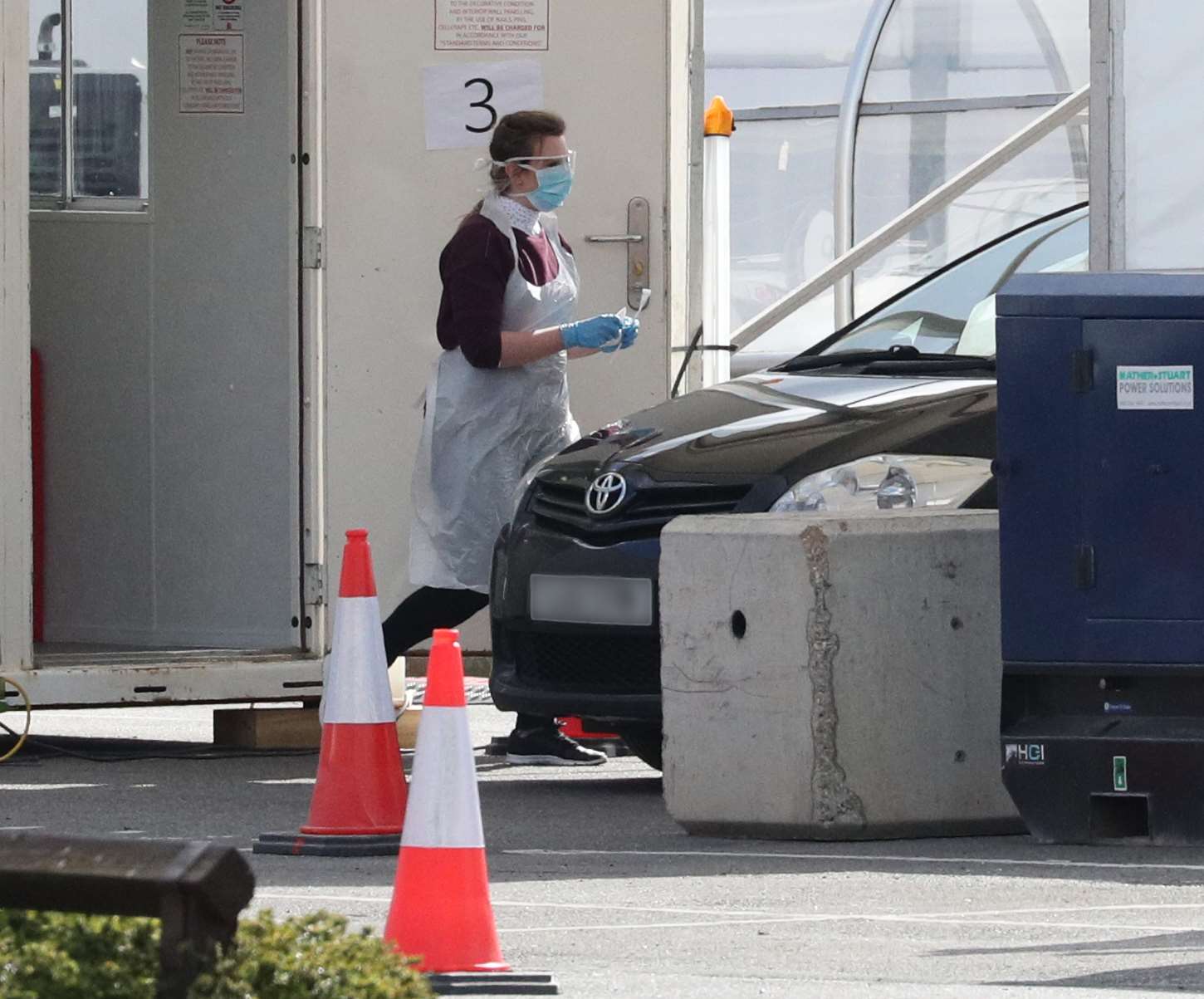 A person holds a swab at a Covid-19 drive-through test centre for NHS workers which has opened at Ikea store in Wembley, north-west London.