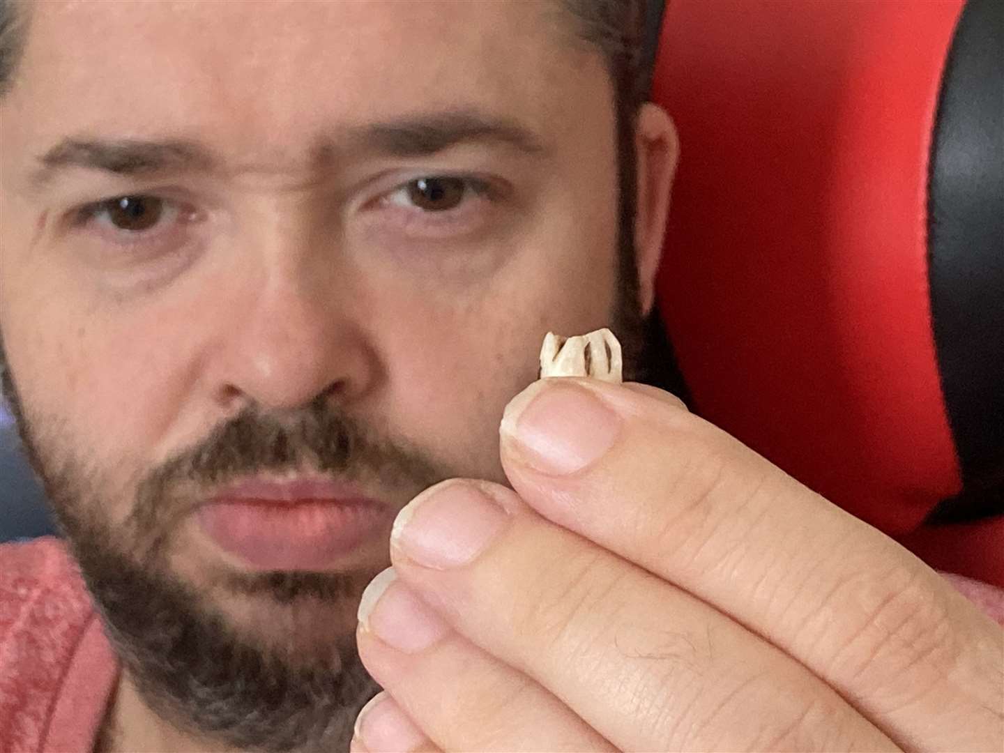 Adam Young, 36, from Clyde Street, Sheerness, and the tooth he found in a tin of Fray Bentos minced beef and onion pie. Picture: John Nurden