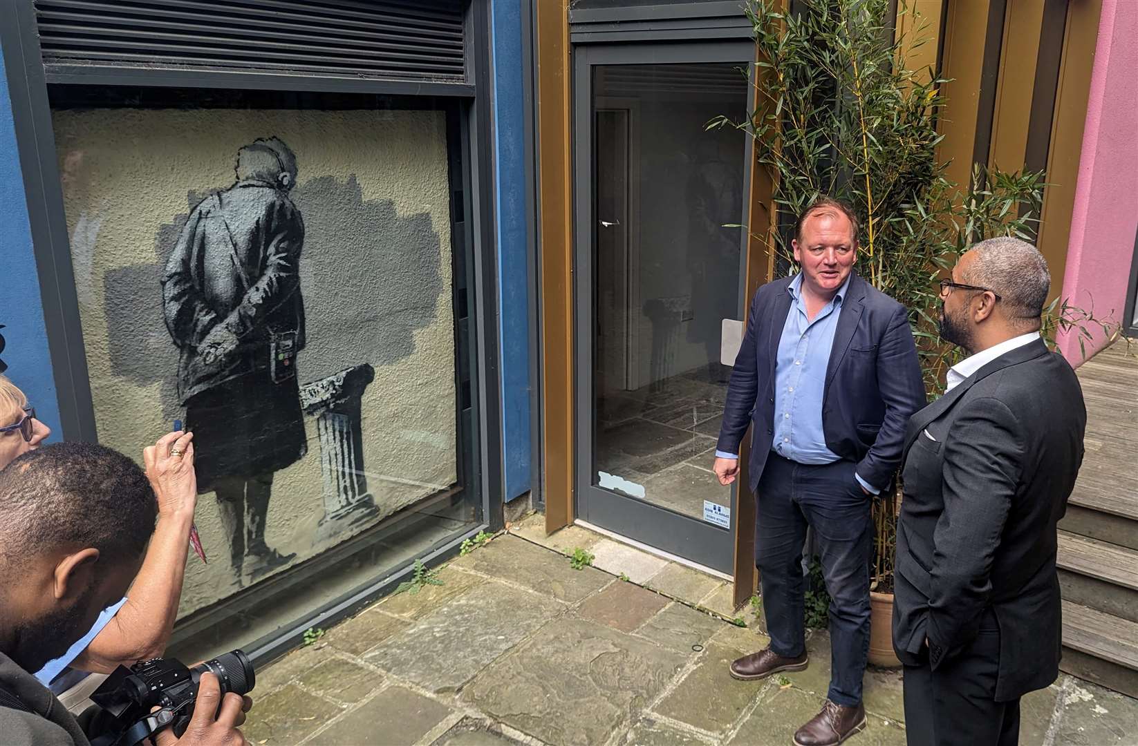 Damian Collins shows James Cleverly the Banksy artwork in Folkestone’s Old High Street