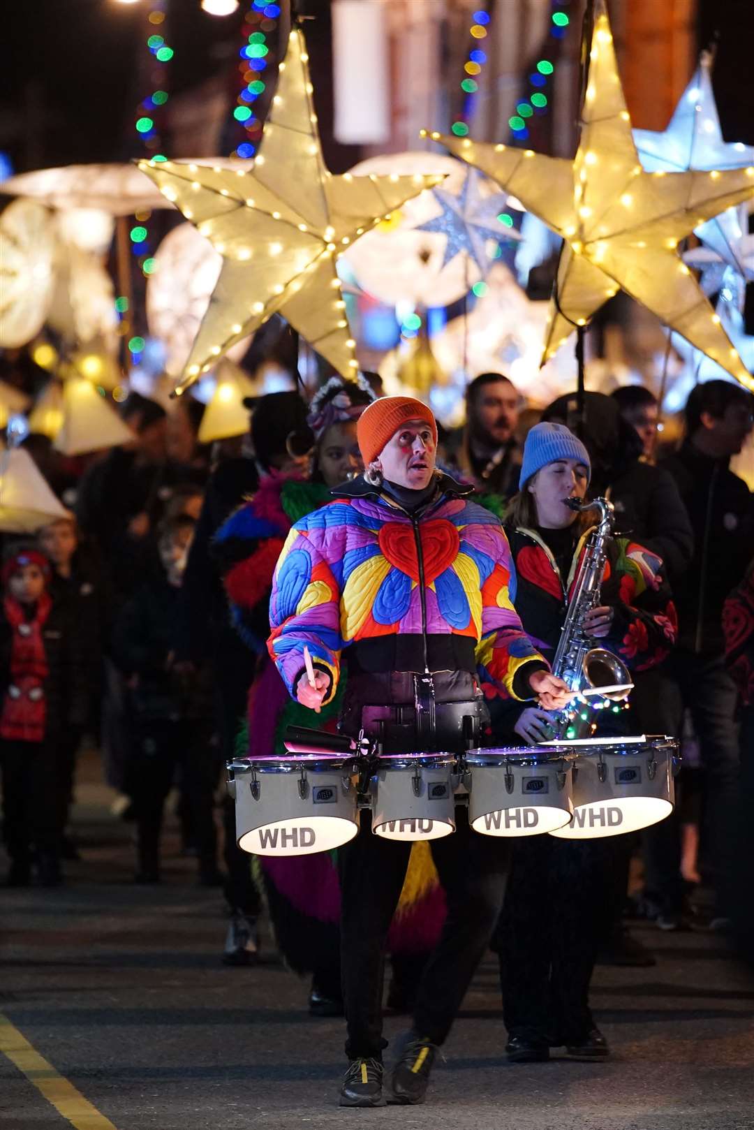 People take part in a lantern parade in Liverpool to mark the reopening of Spellow Community Hub (Peter Byrne/PA)