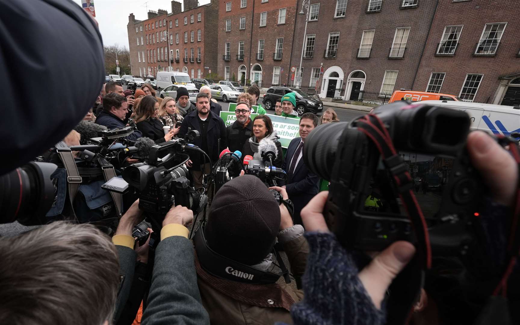 Sinn Fein leader Mary Lou McDonald speaking to the media with candidates Eoin O Broin (centre left), Matt Carthy (centre right) and supporters outside Government Buildings, Dublin (Brian Lawless/PA)