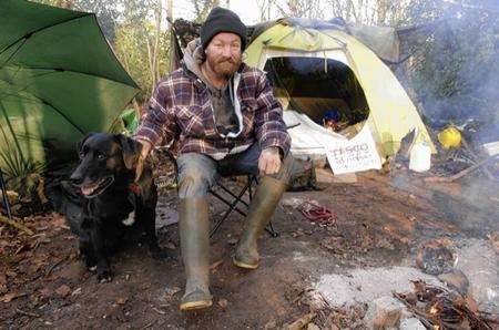 Steve Williamson, who has lived in woods for years, with his dog