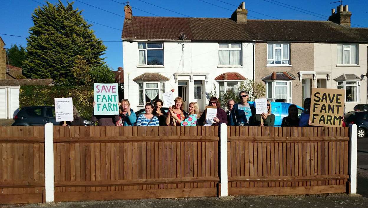 Residents protest outside the meeting