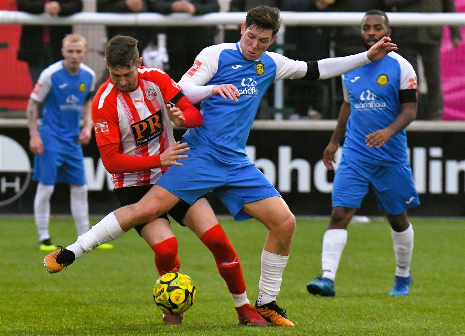 Sheppey striker Dan Bradshaw (red) battles for possession against Mertsham on Saturday. Picture: Marc Richards