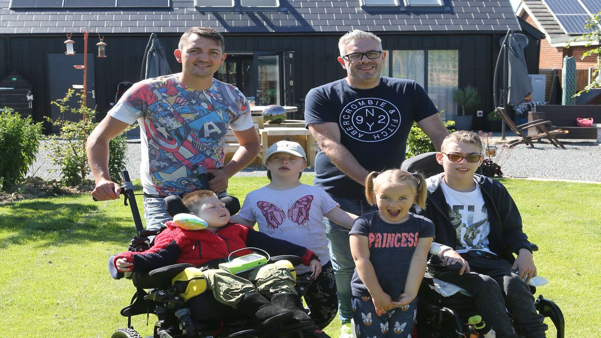 The Ratcliffe family in the back garden of their new home