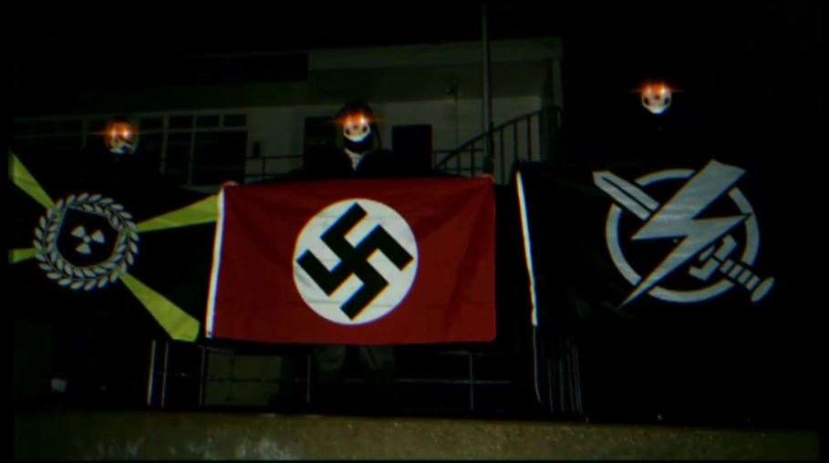 An image of three figures with red eyes holding flags, which was recovered from devices belonging to Andrew Dymock (Counter Terrorism Policing North East/PA)