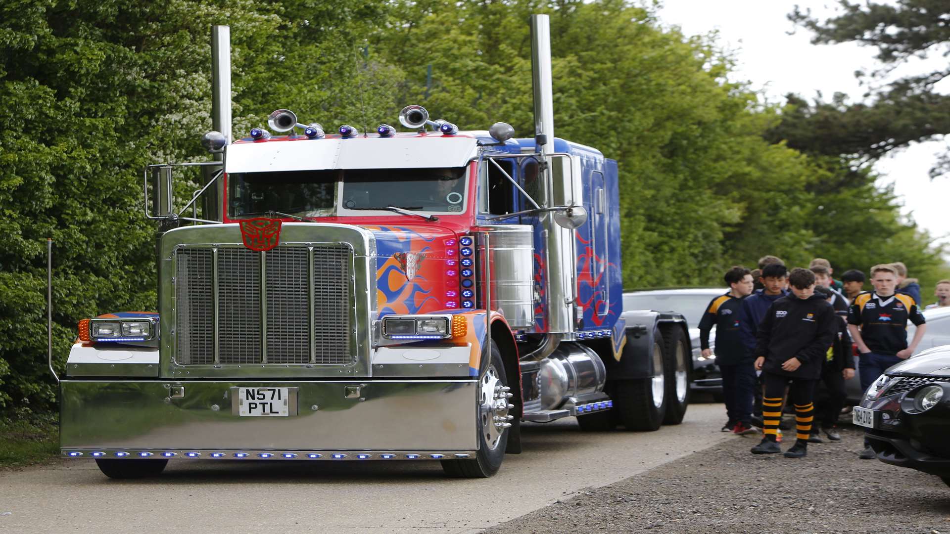 Troy's rugby teammate walk beside the truck