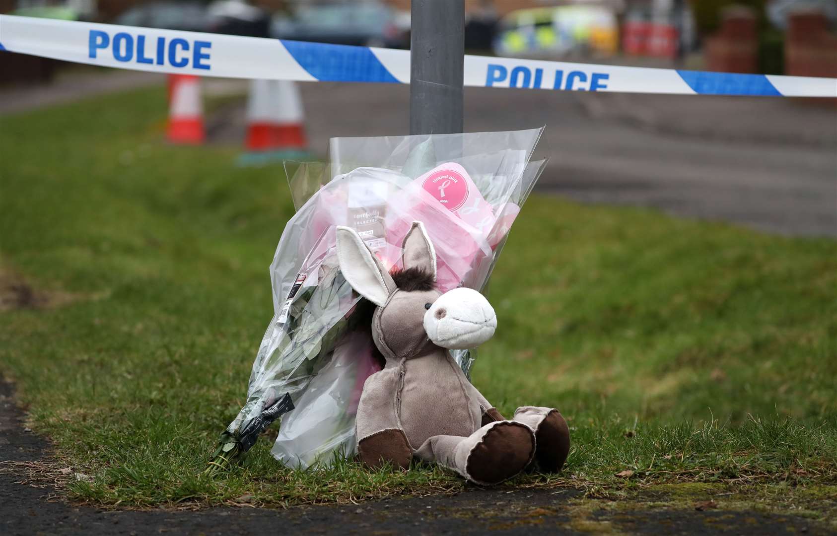 Flowers and a teddy bear left at the entrance to Innes’ home (Andrew Milligan/PA)