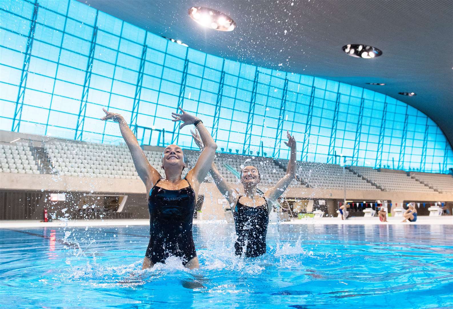 Members of Aquabatix synchronised swimming team Asha Randall, left, and Yixin Zeng make a splash at the centre (Dominic Lipinski/PA)