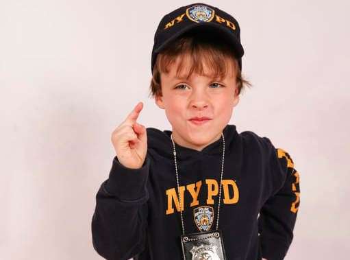 Twin Max dresses up as a police officer for a pageant