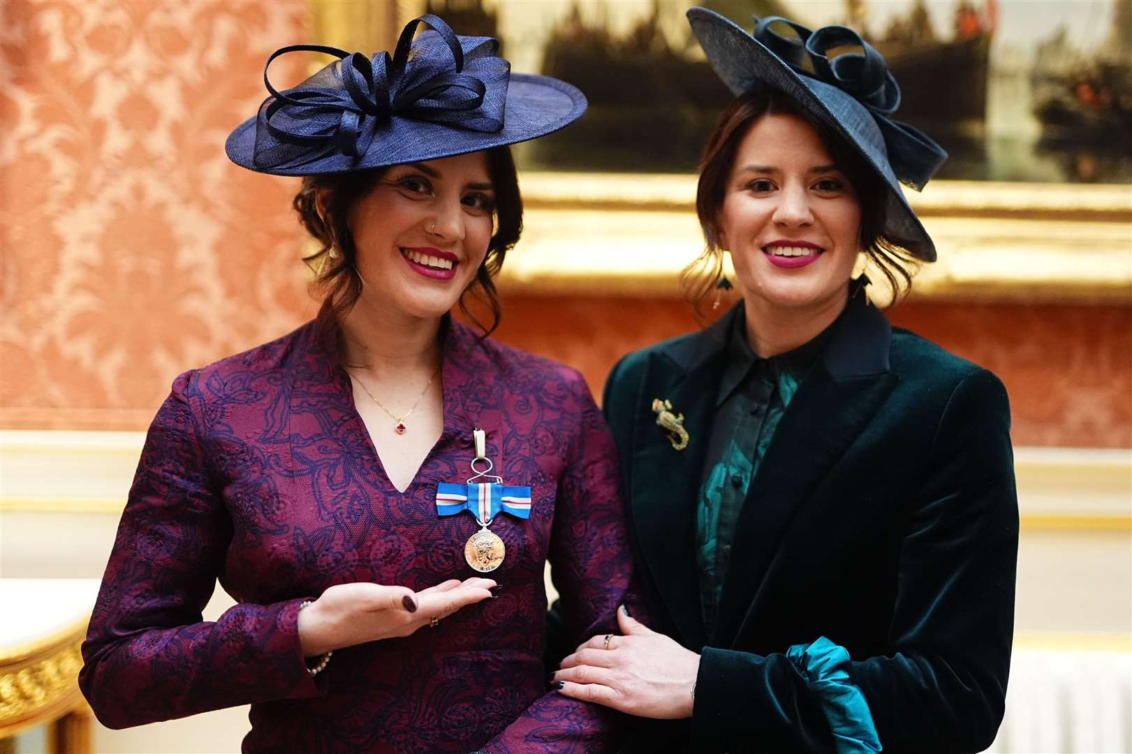 Georgia Laurie (left), with her sister Melissa, after she was decorated with the King’s Gallantry Medal by the King (Aaron Chown/PA)