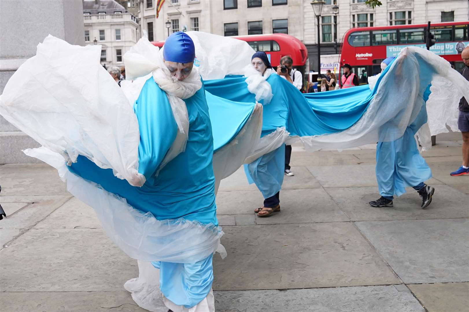 Members of Extinction Rebellion in Trafalgar Square, dressed as the sea (Stefan Rousseau/PA)