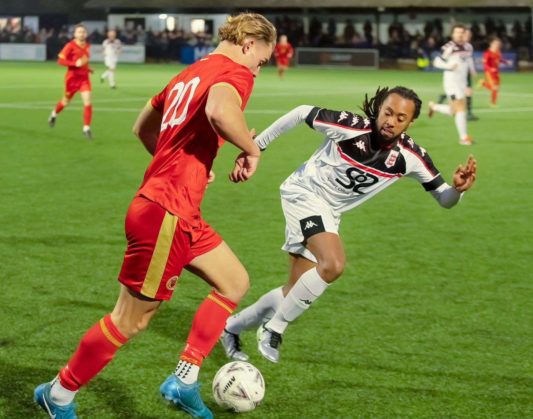 Whitstable forward Ashdon Day runs at Faversham defender Bradley Simms. Picture: Les Biggs